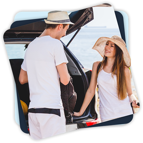 Happy Couple with their car at the beach