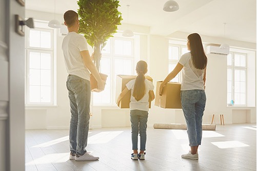 People moving into a house with a flat roof
