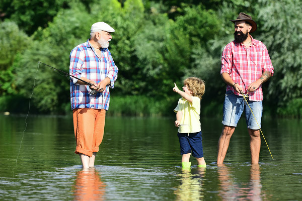 Father, Son and Grandson fishing in a river